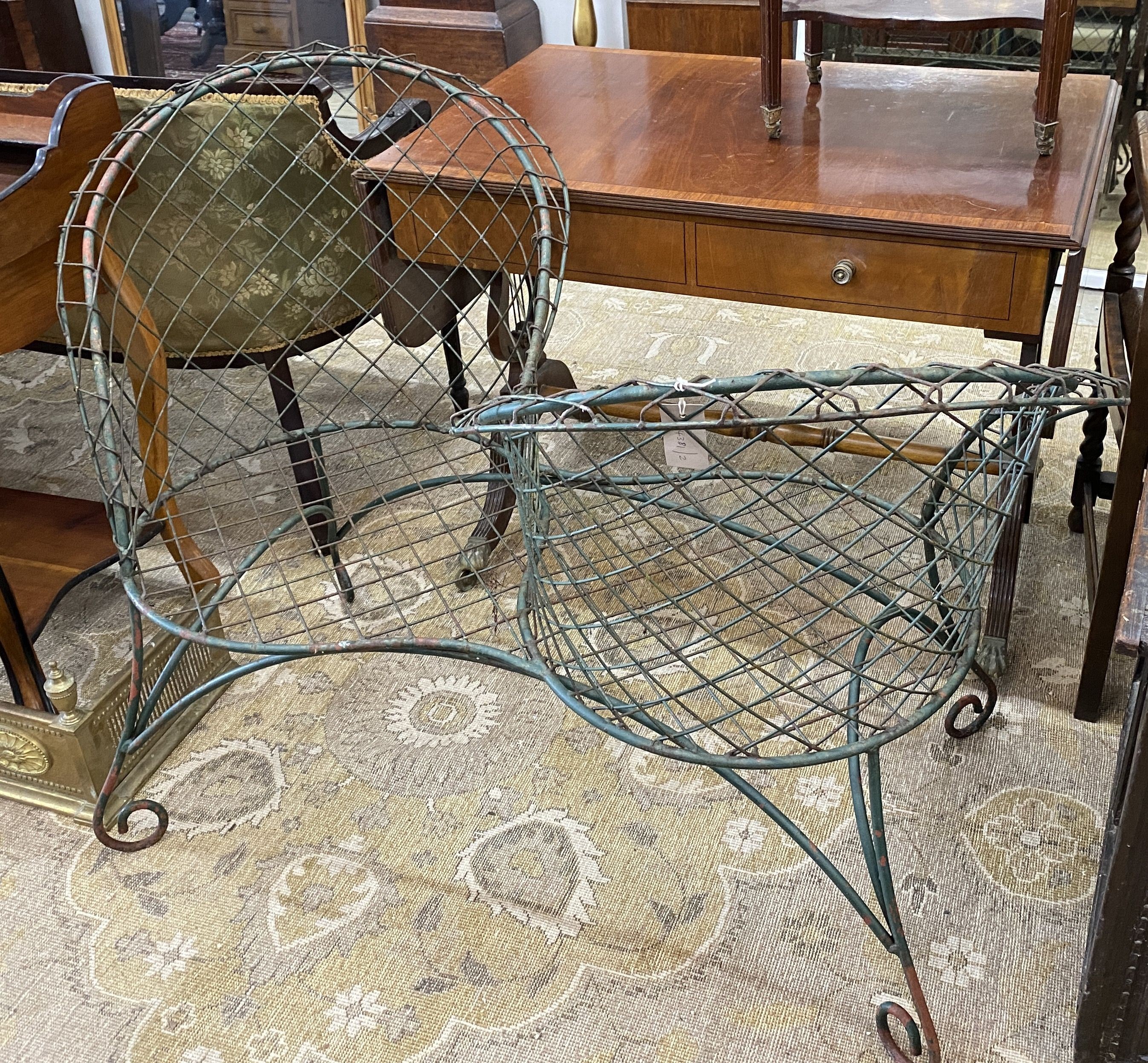 A painted wrought iron and wirework garden love seat, width 126cm, depth 50cm, height 90cm